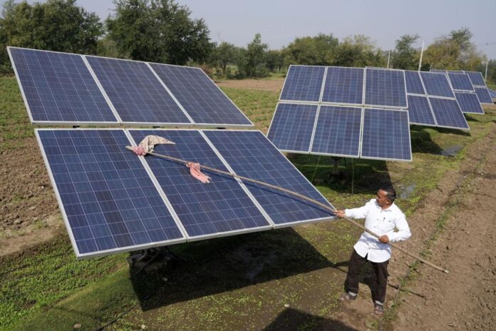 The solar panels, wheat, and rice, have been lining Pravinbhai Parmar's farm in Gujarat state in western India for six years. He is one of a select group of farmers in his native Dhundi village who have been irrigating crops with solar electricity