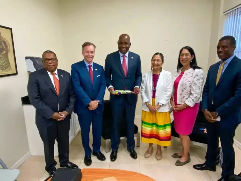 PM Roosevelt Skerrit while receiving Diplomatic Feather from US Ambassador Roger Nyhus