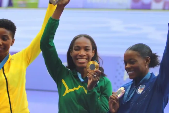 Thea Lafond showcasing her gold medal to the audience. PC: Facebook