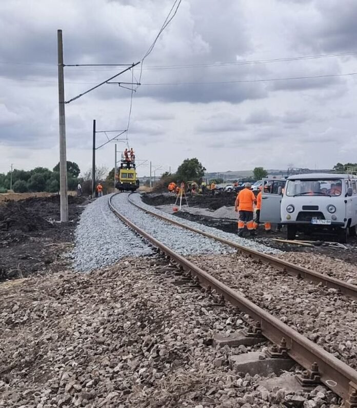 Railway crews repair the damaged Pyasachevo line after a freight train derailment caused fire and severe track destruction